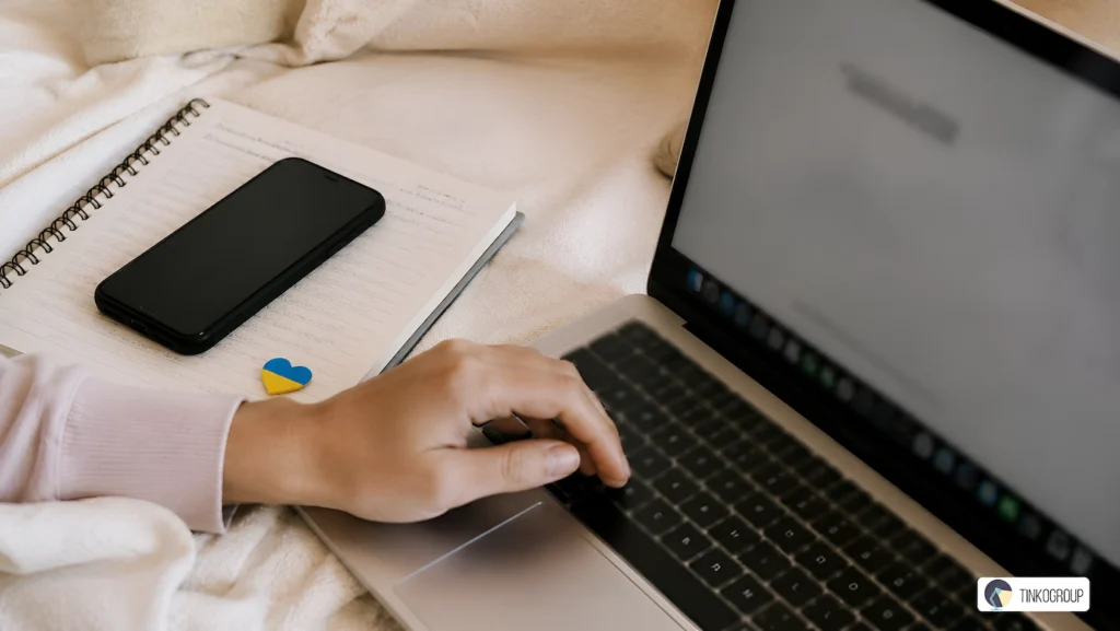 Ethical AI Supply Chain in Ukraine illustrated by a real workspace with laptop, handwritten notes, smartphone, and subtle Ukrainian flag detail