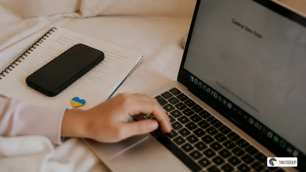 Ethical AI Supply Chain in Ukraine illustrated by a real workspace with laptop, handwritten notes, smartphone, and subtle Ukrainian flag detail